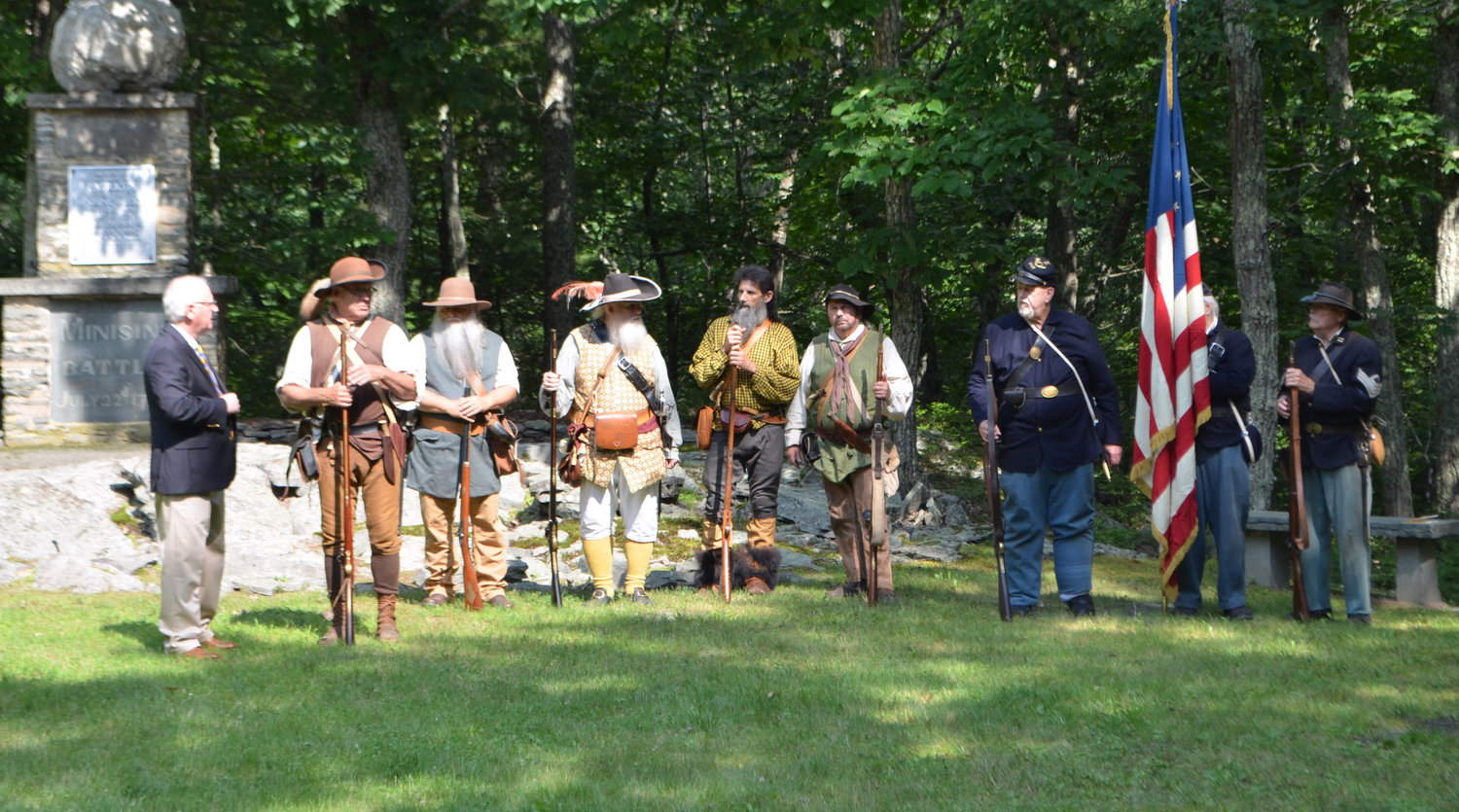 Sullivan County Historian John Conway, left, talks with members of the Navasing Long Rifles, the 5th NY Infantry, and the 143rd NYS Volunteer Infantry, prior to the presentation of the colors.